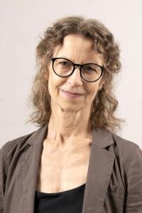A smiling white woman with glasses